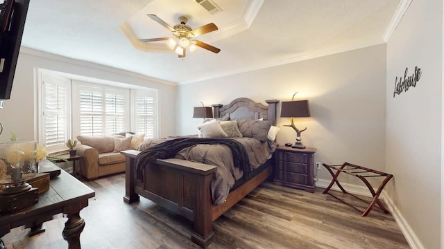 bedroom with ceiling fan, dark wood-type flooring, and ornamental molding