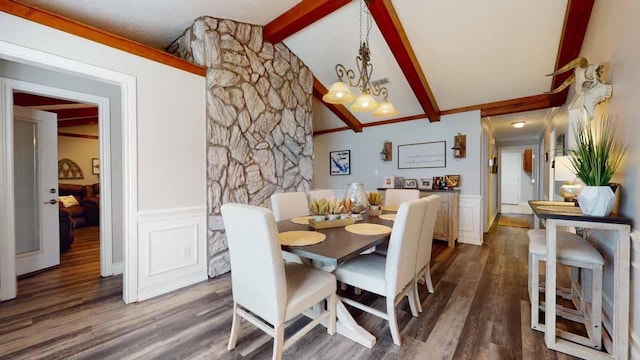 dining area featuring lofted ceiling with beams, dark hardwood / wood-style floors, and a notable chandelier