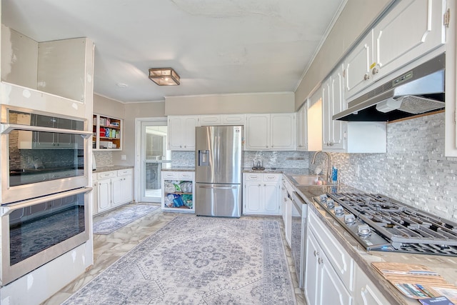 3325 Blackmon Ln, Beaumont, TX 77703 - kitchen featuring stainless steel appliances, under cabinet range hood, ornamental molding, a sink, and tasteful backsplash