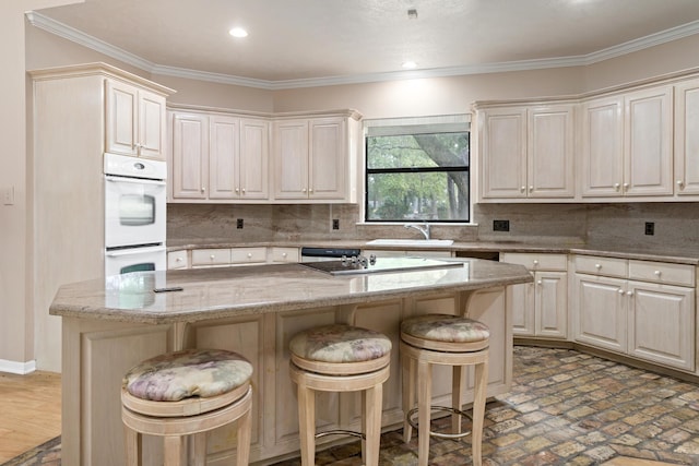 kitchen featuring a center island, a breakfast bar area, and tasteful backsplash