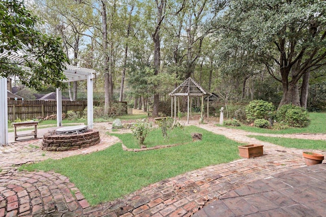 view of yard with a pergola, an outdoor fire pit, and a patio area