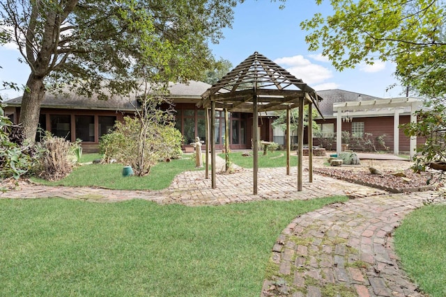 view of yard with a sunroom and a pergola