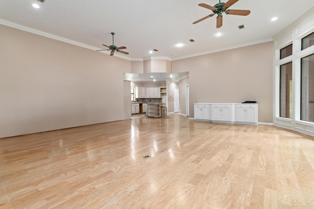 unfurnished living room featuring light hardwood / wood-style flooring, ceiling fan, and crown molding