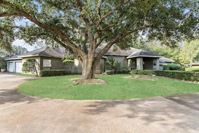 view of front of home with a garage and a front lawn