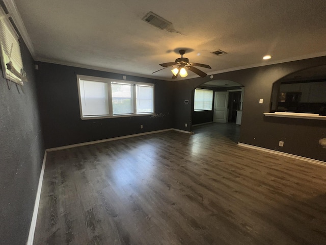 5333 Lakeside Dr, Port Arthur, TX 77642 - unfurnished living room with crown molding, wood finished floors, arched walkways, a ceiling fan, and recessed lighting