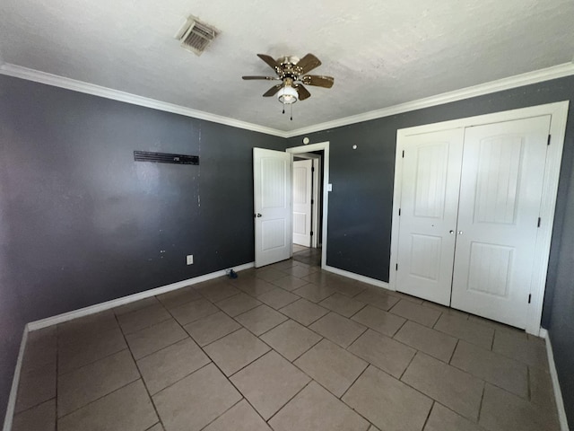 5333 Lakeside Dr, Port Arthur, TX 77642 - unfurnished bedroom featuring tile patterned floors, ornamental molding, a closet, and a ceiling fan