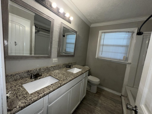 5333 Lakeside Dr, Port Arthur, TX 77642 - bathroom featuring double vanity, crown molding, wood finished floors, and a textured ceiling