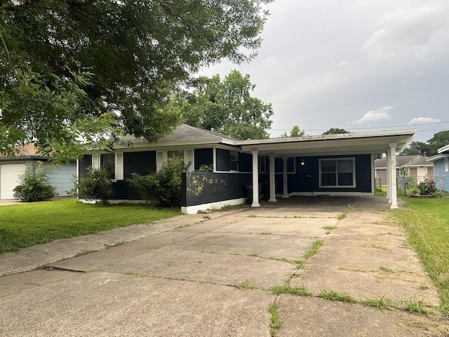 5333 Lakeside Dr, Port Arthur, TX 77642 - view of front of property featuring concrete driveway, a front lawn, and a carport