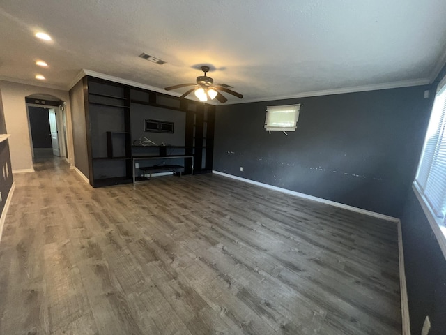 5333 Lakeside Dr, Port Arthur, TX 77642 - unfurnished living room with a ceiling fan, crown molding, wood finished floors, arched walkways, and recessed lighting