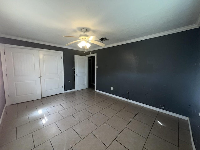 5333 Lakeside Dr, Port Arthur, TX 77642 - unfurnished bedroom featuring tile patterned flooring, a closet, ornamental molding, and a ceiling fan