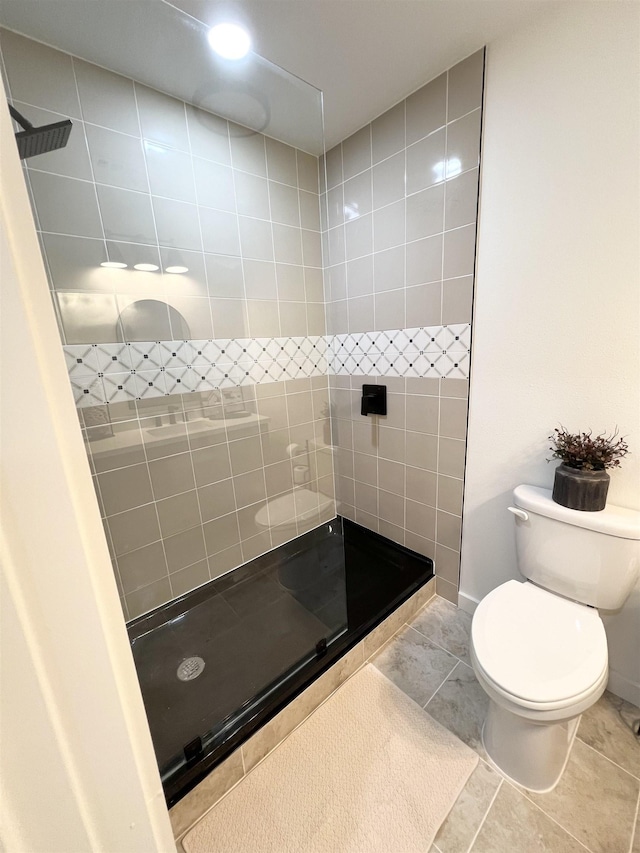 bathroom featuring tile patterned floors, toilet, and a shower