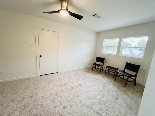 sitting room with light colored carpet and ceiling fan