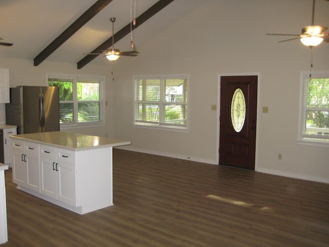 kitchen with stainless steel fridge, dark hardwood / wood-style flooring, high vaulted ceiling, white cabinets, and a center island