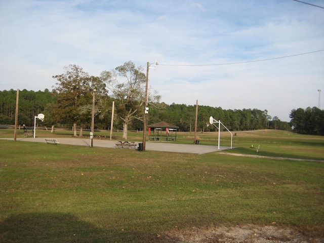 surrounding community with a gazebo, a yard, and basketball court