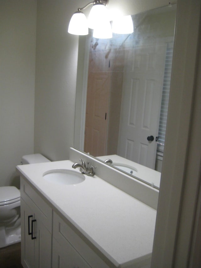 bathroom featuring vanity and toilet