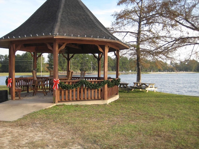 view of community with a gazebo, a water view, and a yard