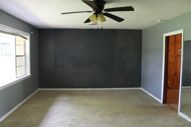 4246 Griffing Dr, Port Arthur, TX 77642 - spare room featuring carpet flooring, a ceiling fan, baseboards, and a textured ceiling
