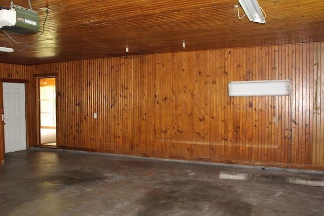 4246 Griffing Dr, Port Arthur, TX 77642 - garage featuring a garage door opener and wood walls