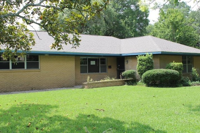 4246 Griffing Dr, Port Arthur, TX 77642 - ranch-style house with a front yard, brick siding, and roof with shingles