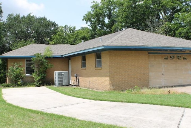 4246 Griffing Dr, Port Arthur, TX 77642 - view of front facade with central air condition unit, brick siding, and a shingled roof