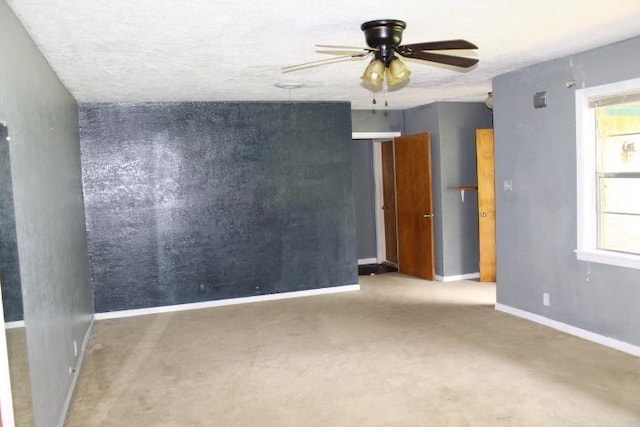4246 Griffing Dr, Port Arthur, TX 77642 - unfurnished room with ceiling fan, healthy amount of natural light, baseboards, and a textured ceiling