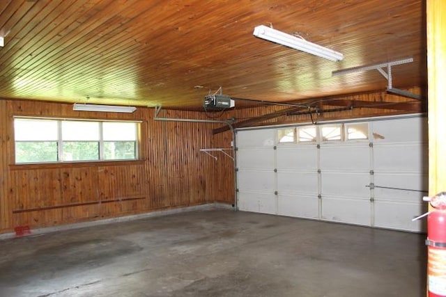 4246 Griffing Dr, Port Arthur, TX 77642 - garage featuring wood walls, wooden ceiling, and a garage door opener