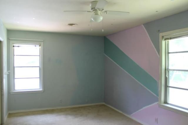 4246 Griffing Dr, Port Arthur, TX 77642 - spare room featuring plenty of natural light, baseboards, light carpet, and a ceiling fan