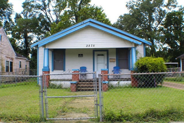 3575 Magnolia Ave, Beaumont, TX 77703 - shotgun-style home with a porch, a gate, and a fenced front yard