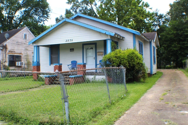 3575 Magnolia Ave, Beaumont, TX 77703 - bungalow-style home with covered porch, a fenced front yard, and driveway