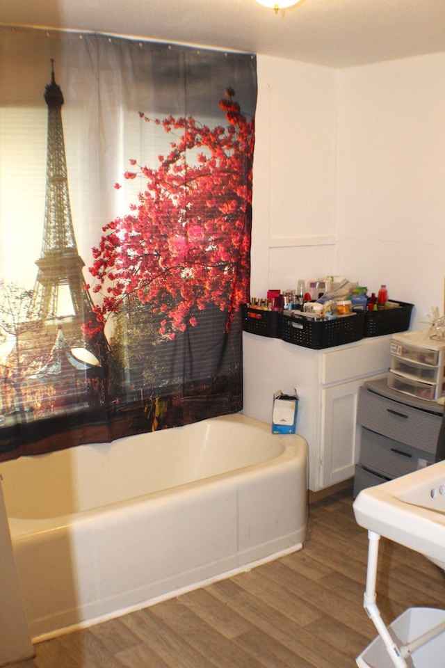 3575 Magnolia Ave, Beaumont, TX 77703 - bathroom with a bathtub and wood finished floors