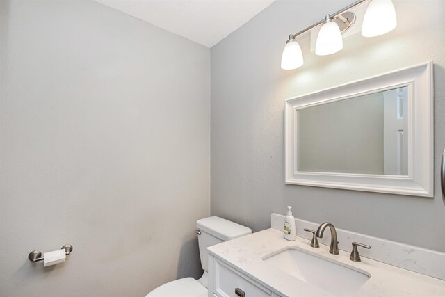 bathroom with toilet and vanity