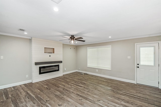 unfurnished living room featuring ceiling fan, ornamental molding, a fireplace, and hardwood / wood-style flooring