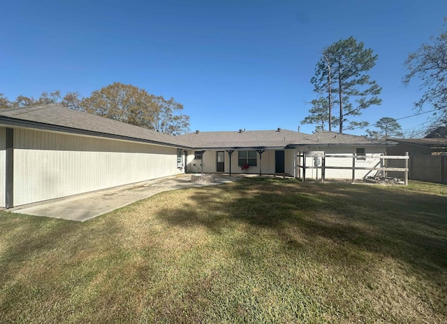 back of house with a yard and a patio