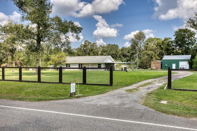 view of property's community with a lawn and an outbuilding