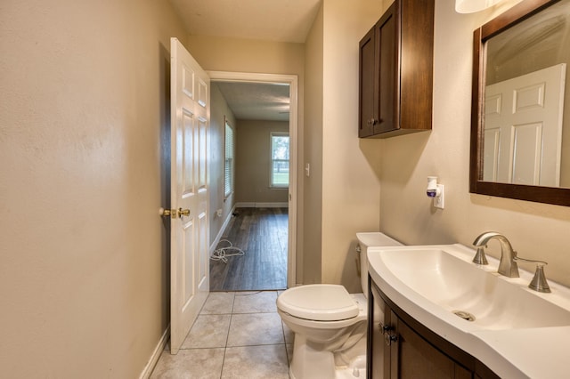 bathroom featuring tile patterned floors, vanity, and toilet