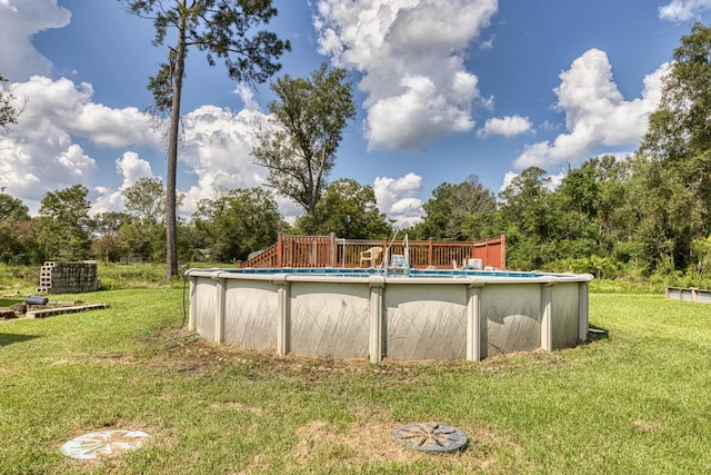 view of pool featuring a yard