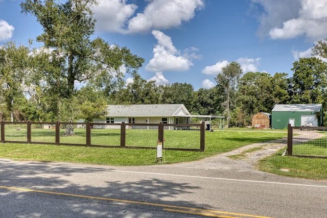 view of home's community featuring a yard and an outdoor structure