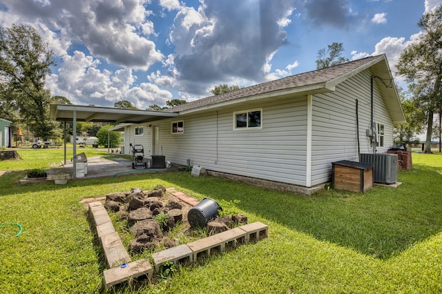 rear view of house featuring a patio area, a yard, and cooling unit