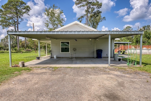 view of car parking featuring a carport and a lawn