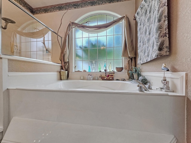 404 Pintail Ln, Orange, TX 77630 - bathroom featuring a tile shower, a bath, and a textured wall