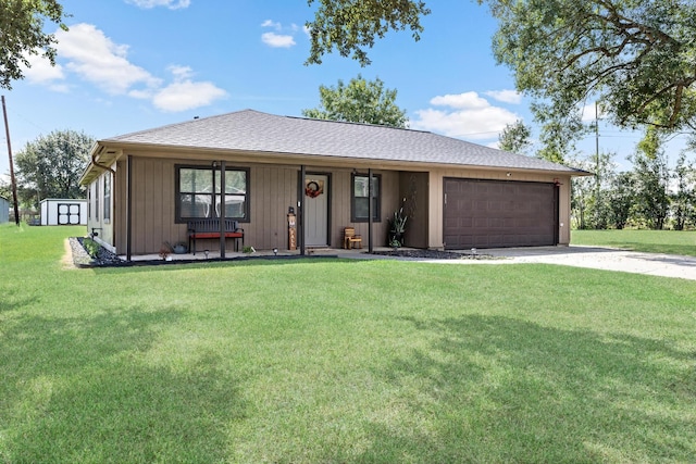 single story home with a porch, a garage, and a front yard