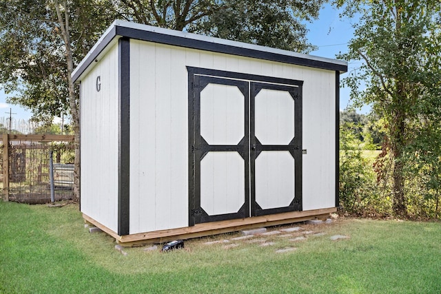 view of outbuilding featuring a lawn