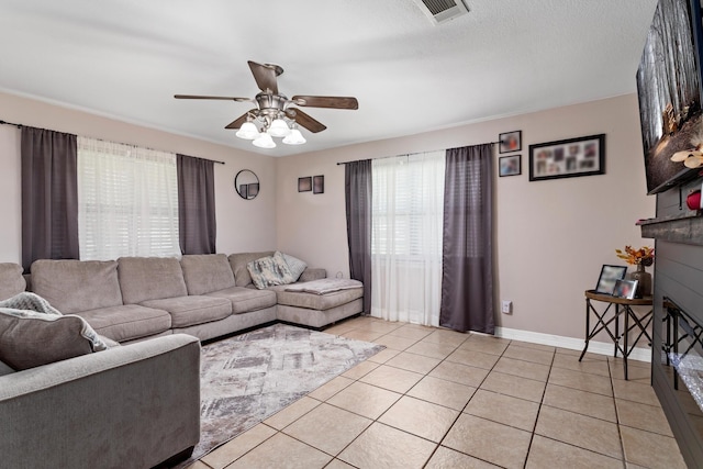 living room featuring light tile patterned floors and ceiling fan