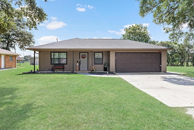 ranch-style home featuring a garage and a front lawn