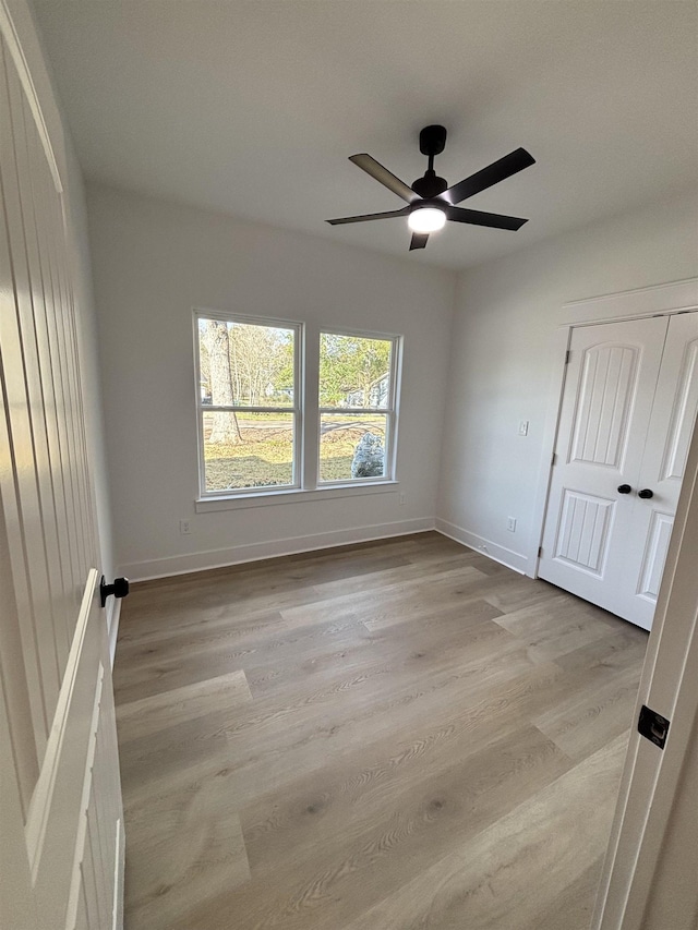 spare room featuring ceiling fan and light wood-type flooring