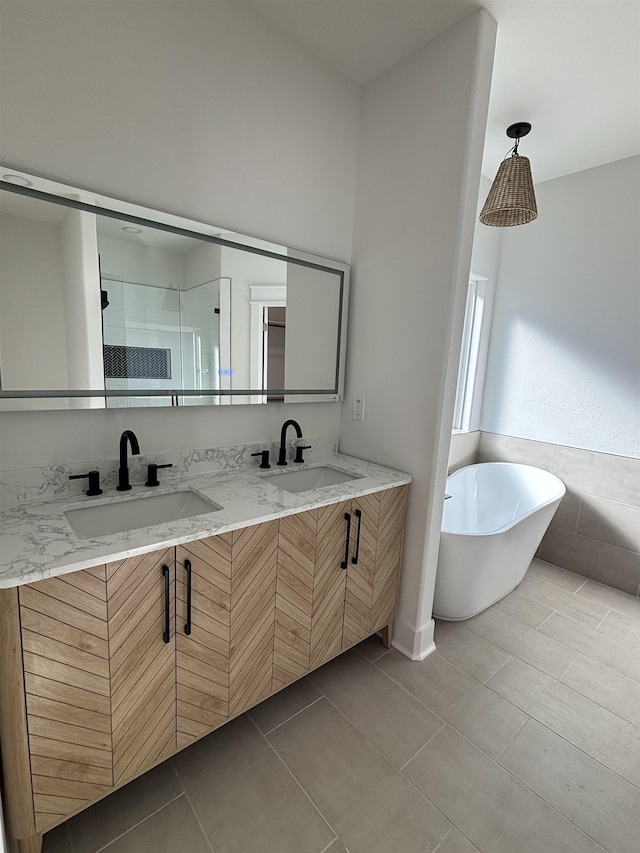 bathroom with separate shower and tub, vanity, and tile patterned floors