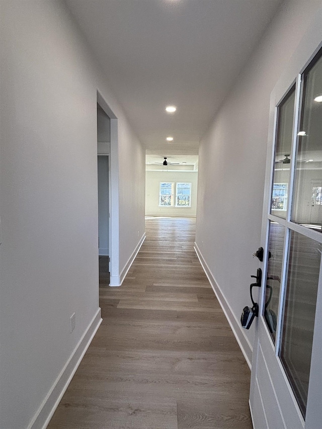 hallway with hardwood / wood-style floors