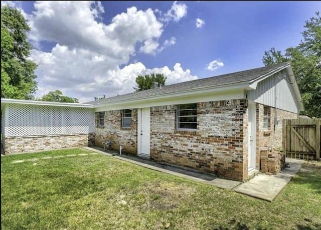 5390 Swallow Dr, Beaumont, TX 77707 - back of property with a yard and brick siding