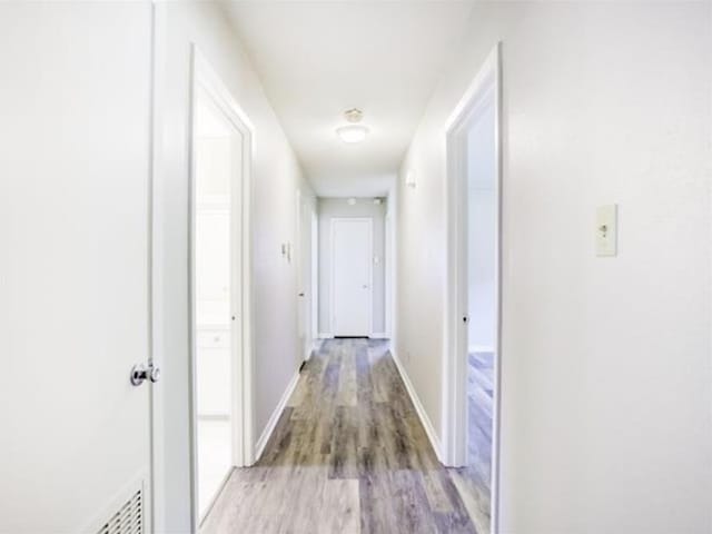 5390 Swallow Dr, Beaumont, TX 77707 - hallway featuring light wood-style flooring and baseboards