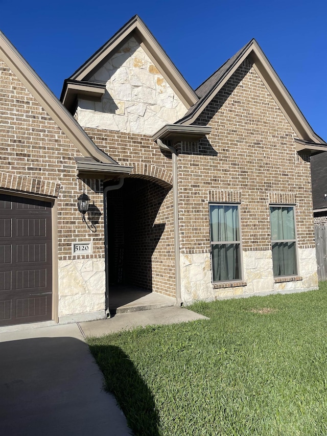 exterior space featuring a lawn and a garage